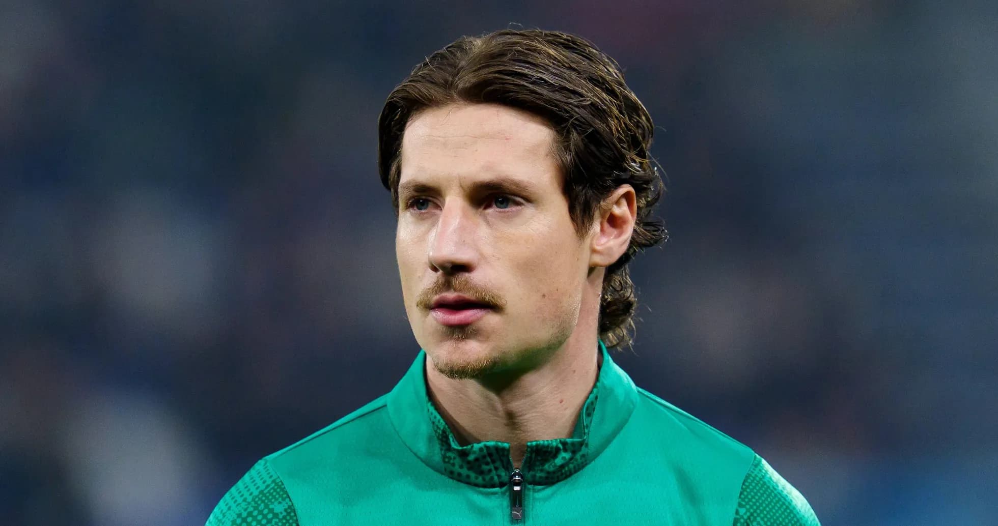 Goalkeeper in green kit during match warm-up