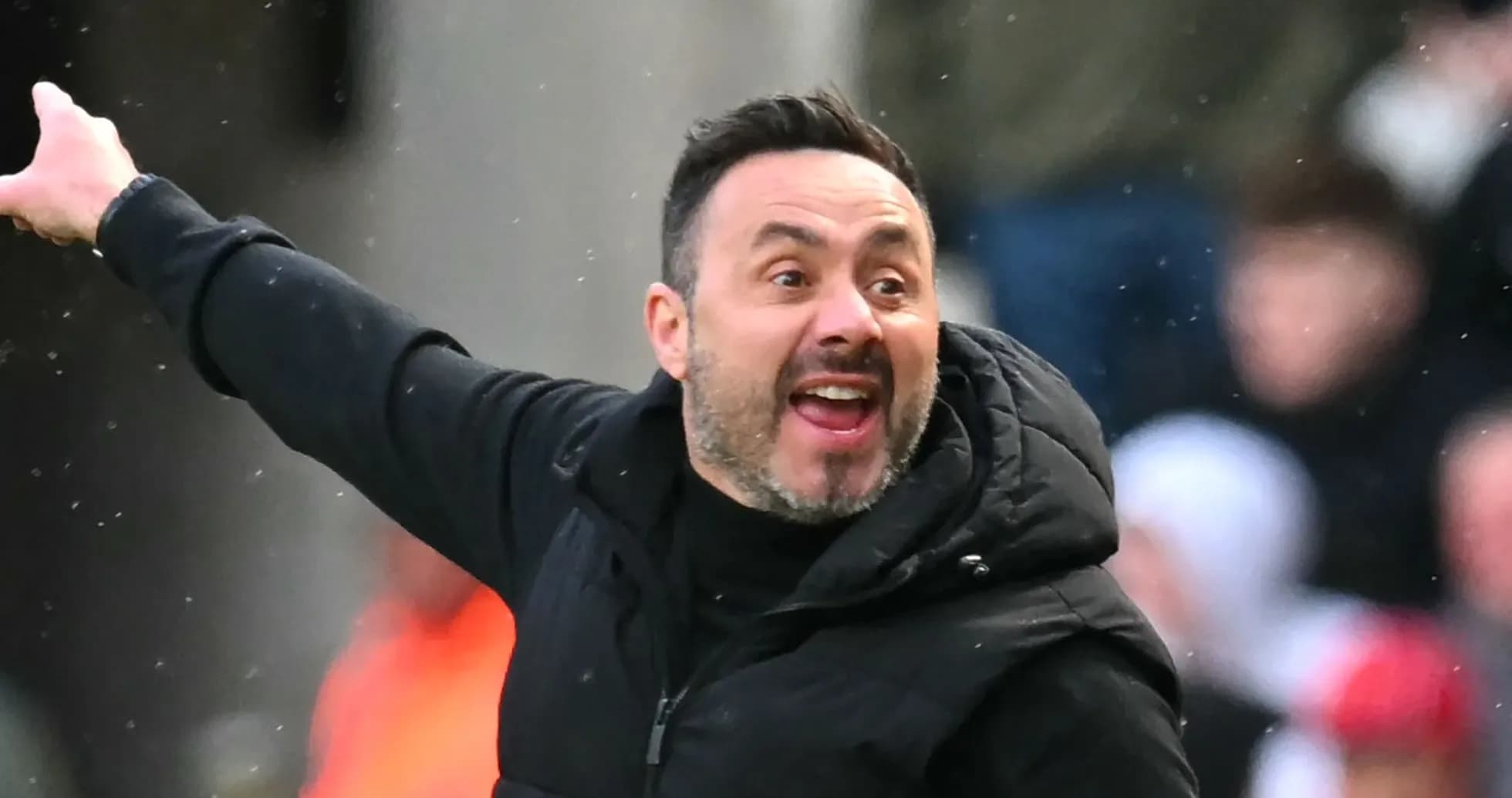 Coach gesturing passionately during a match