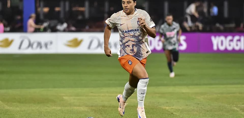 Player sprinting with ball during soccer match