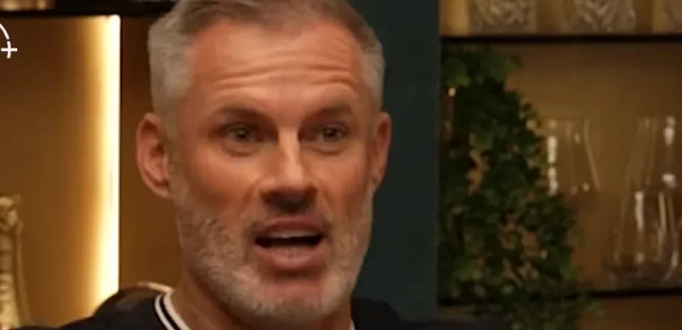Man speaking animatedly in a discussion setting