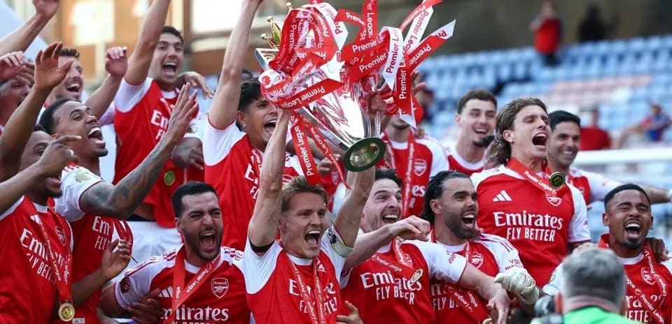 Arsenal players celebrating with Premier League trophy