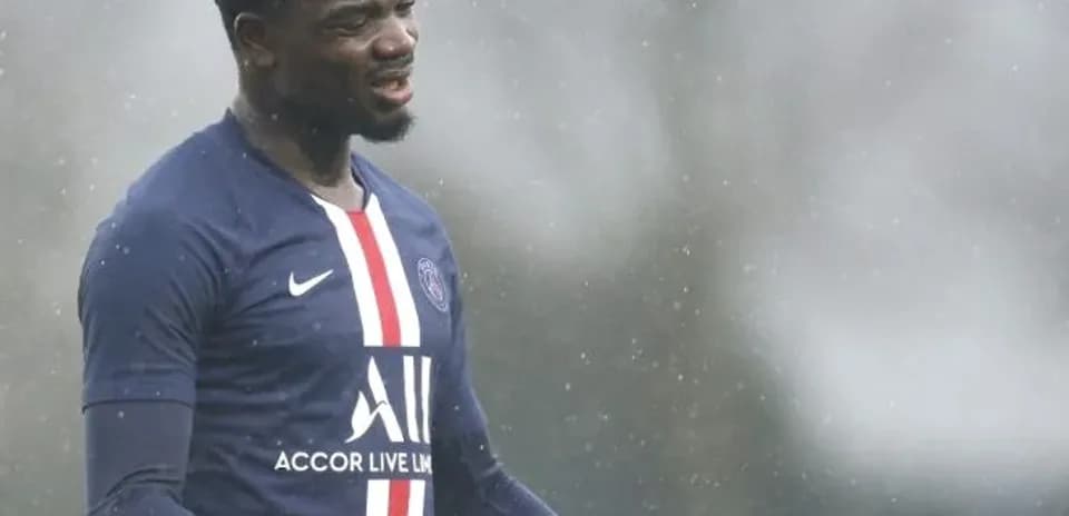 Player gesturing during training in rainy weather