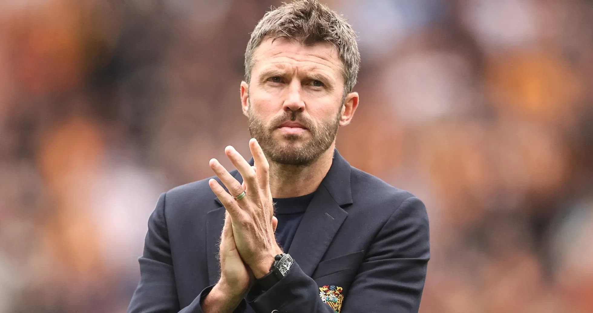 Coach clapping on the sidelines during a match