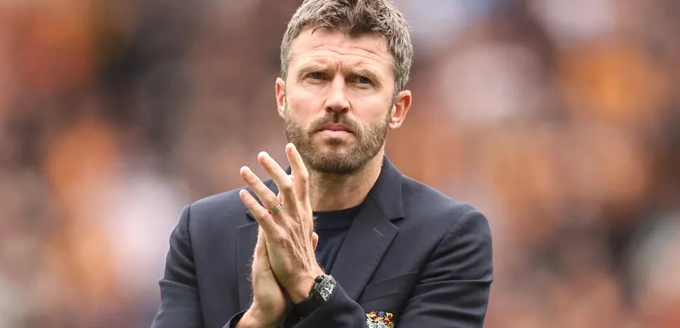 Coach clapping on the sidelines during a match