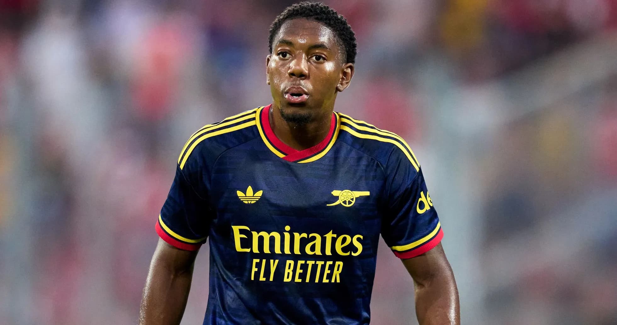 Player wearing Arsenal jersey during match action