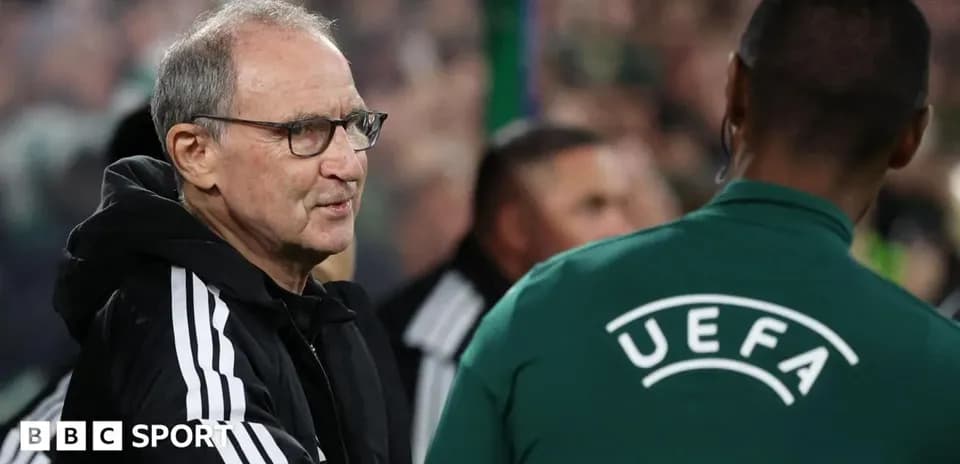 Manager interacting with UEFA official during match