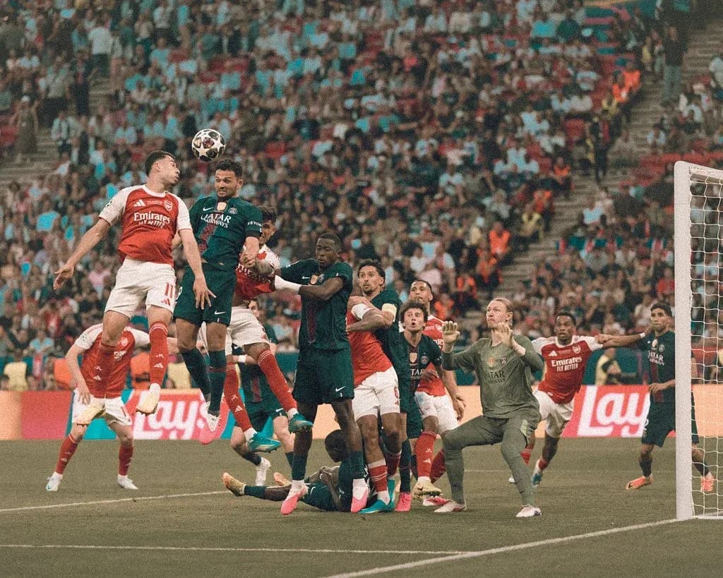 Players contesting a corner kick in football match