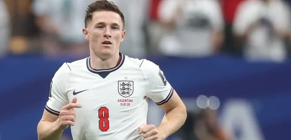 Player in England jersey running on the pitch