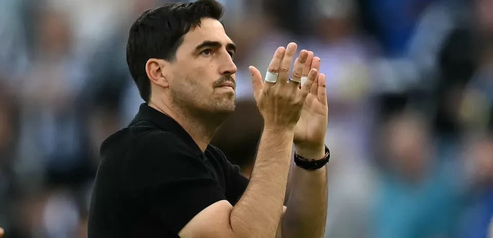 Coach applauding fans during match celebration