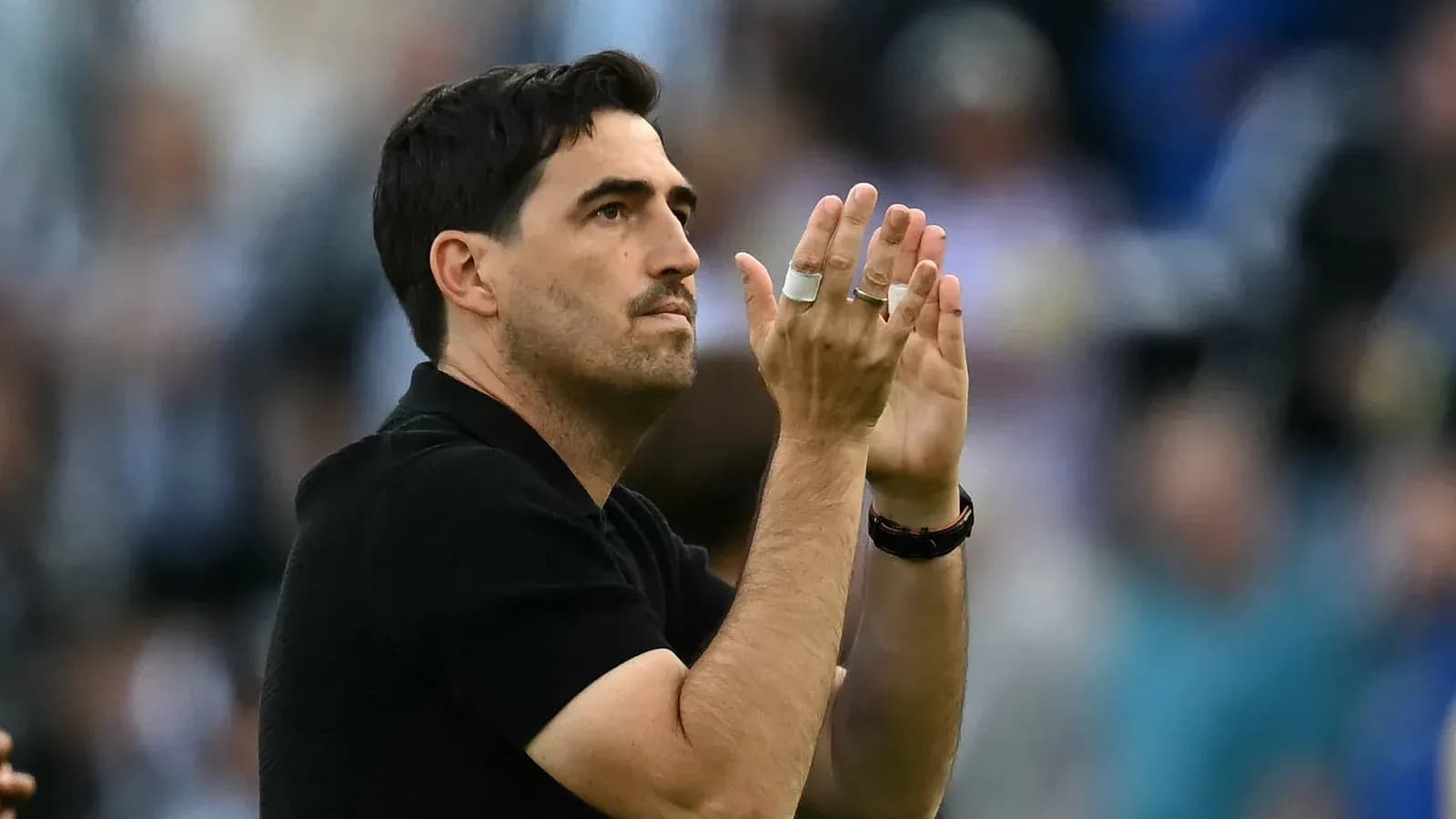 Coach applauding fans during match celebration