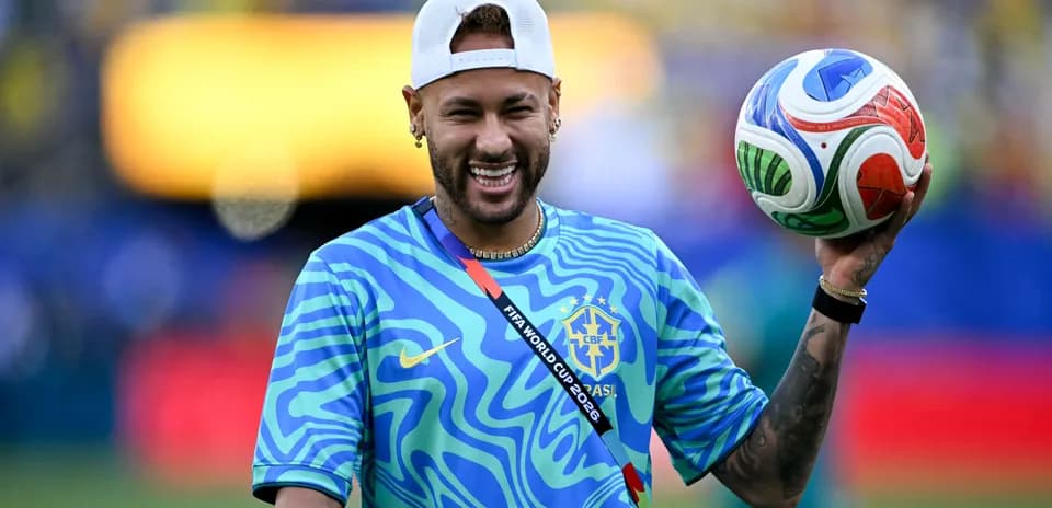 Player holding a soccer ball in a blue shirt