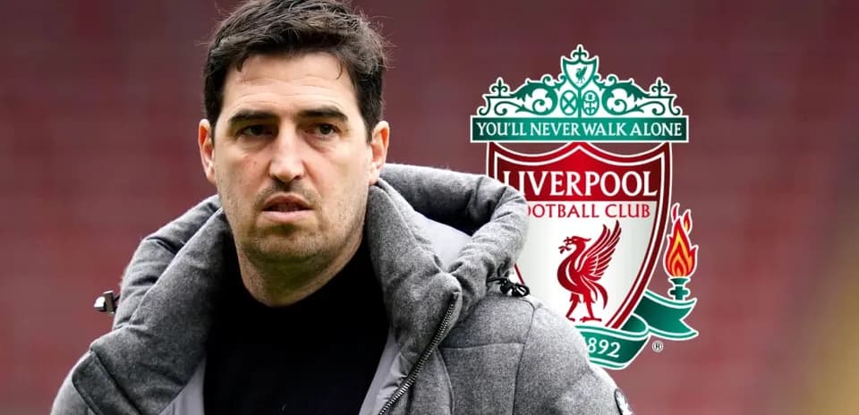 Coach with Liverpool FC logo in background