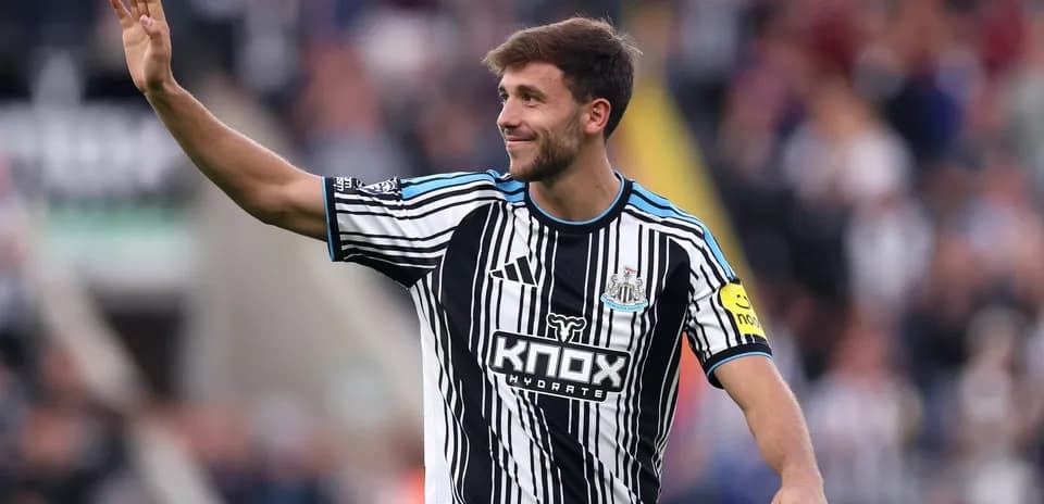 Newcastle player waving to the crowd during match
