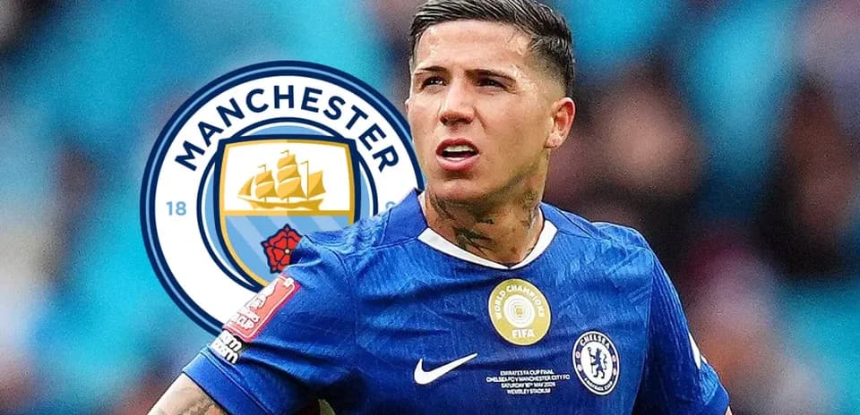 Player in Chelsea kit with Manchester City logo background