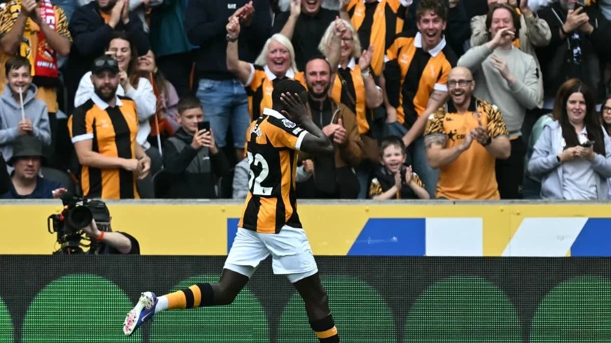 Player celebrating a goal with cheering fans