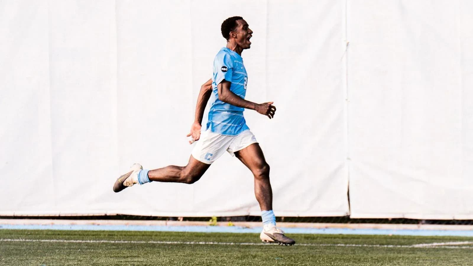 Player celebrating a goal while running on field
