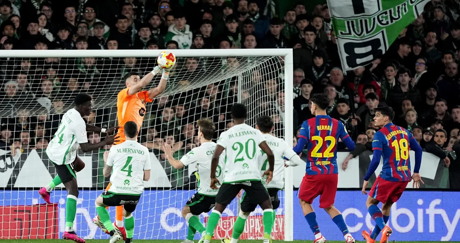 Goalkeeper catching ball during intense match action