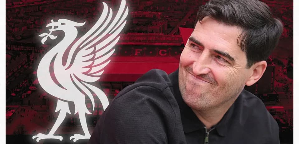 Man smiling in front of Liverpool FC logo