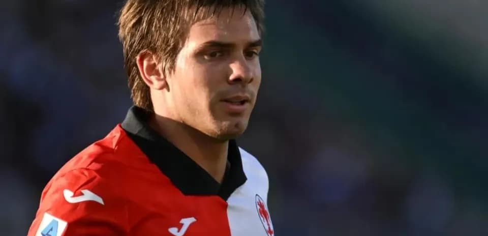 Player in red and white jersey on the field