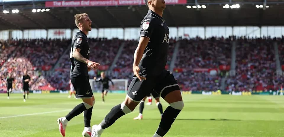 Swansea City player celebrating a goal on pitch
