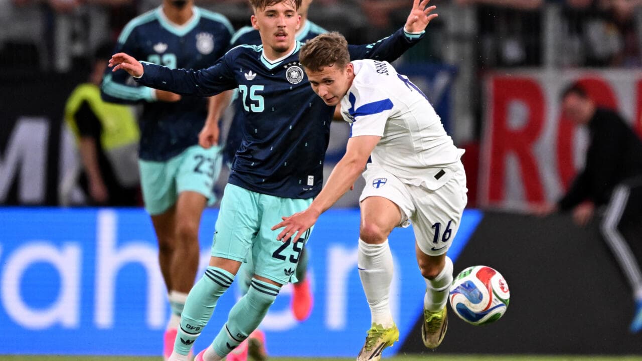 Player from Finland challenged by German opponent during match