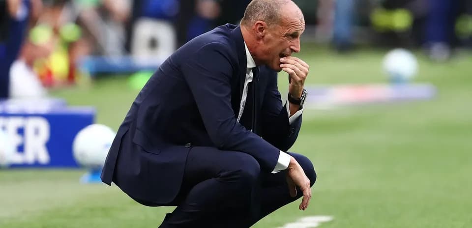 Coach crouched on the sidelines during a match
