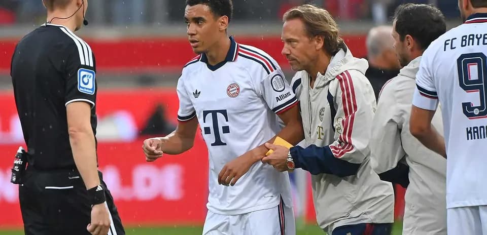 Player receiving instructions from staff during match