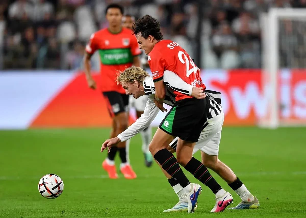 Two players competing for the ball on the field