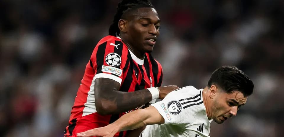 Player in red and black jersey pushing opponent in white