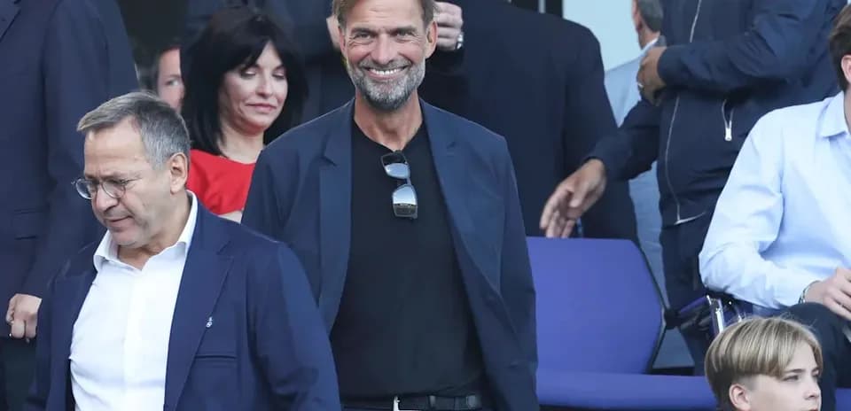 Two men walking in a stadium with spectators