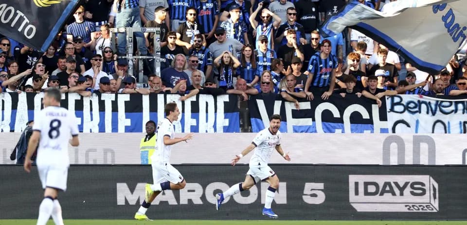 Bologna players celebrating in front of fans