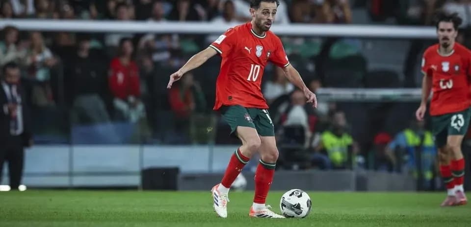 Player in red jersey dribbling ball on field