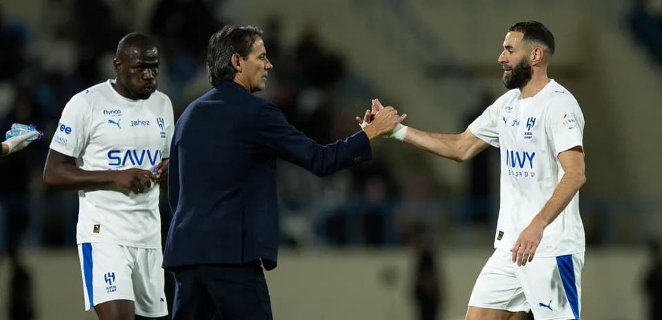 Coach greeting player during match substitution