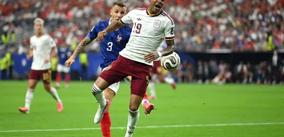 Player tackling opponent during soccer match action