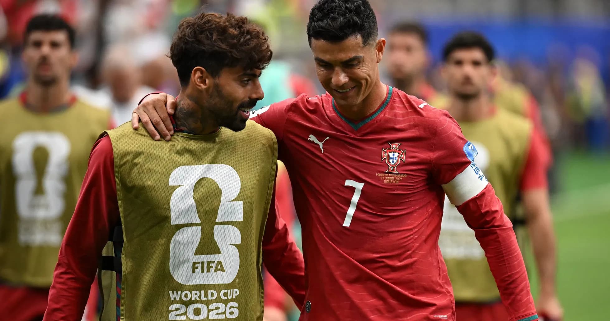 Two Portugal players walking off the field together