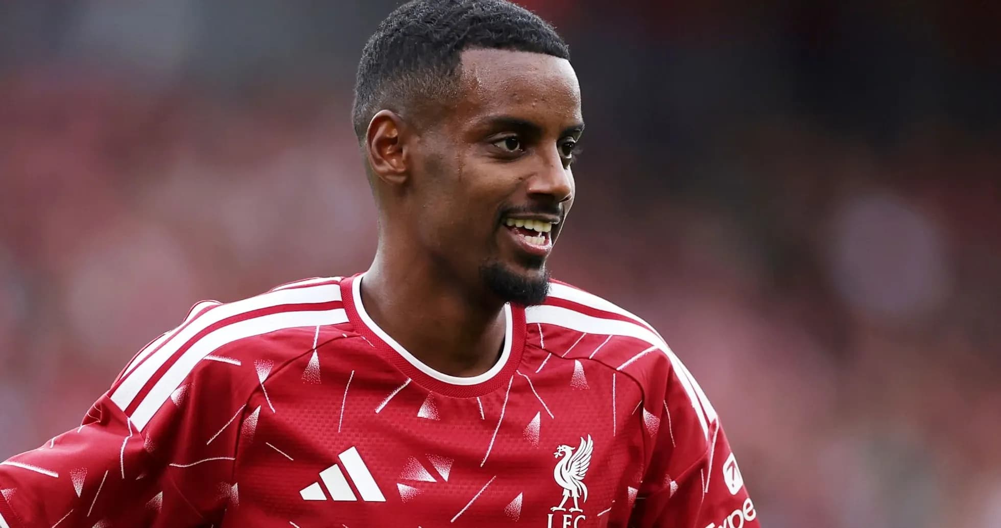 Player smiling in Liverpool FC training jersey