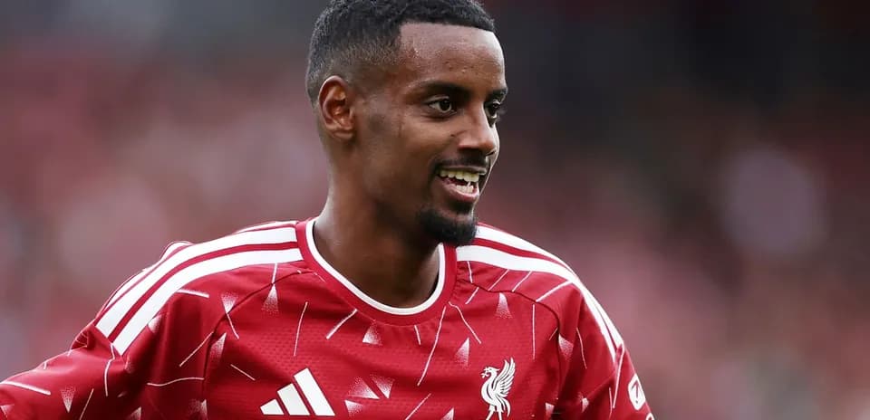 Player smiling in Liverpool FC training jersey