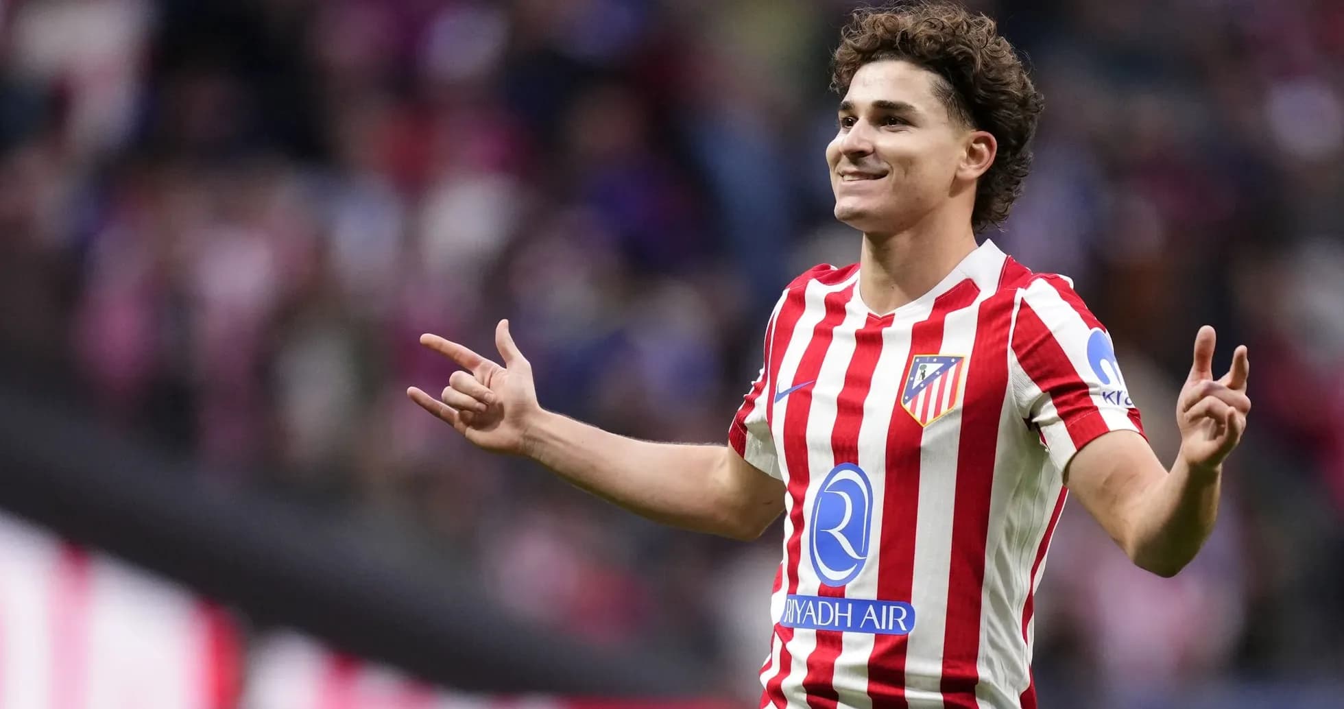 Player celebrating a goal wearing Atlético Madrid jersey