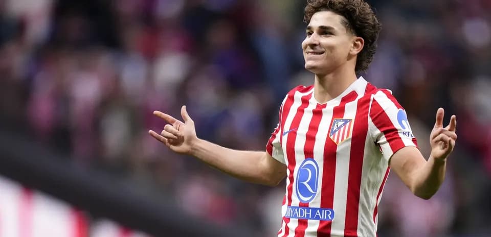Player celebrating a goal wearing Atlético Madrid jersey