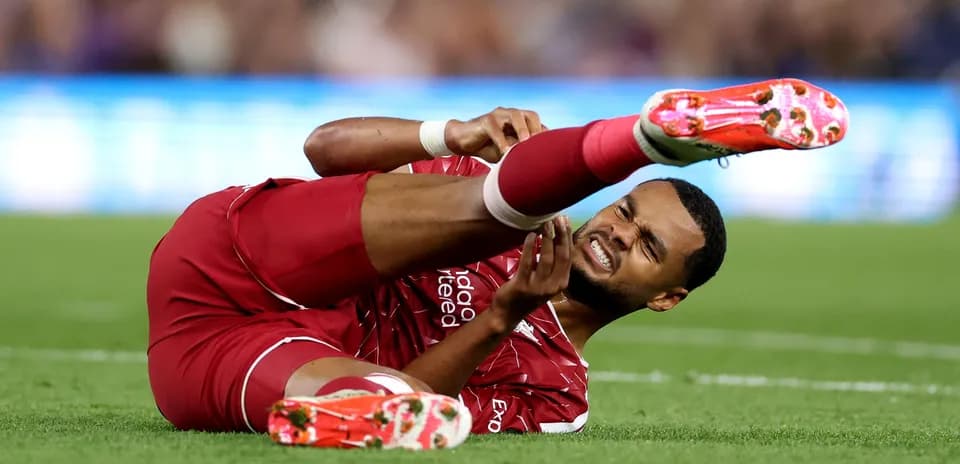 Player lying on the field, holding injured leg