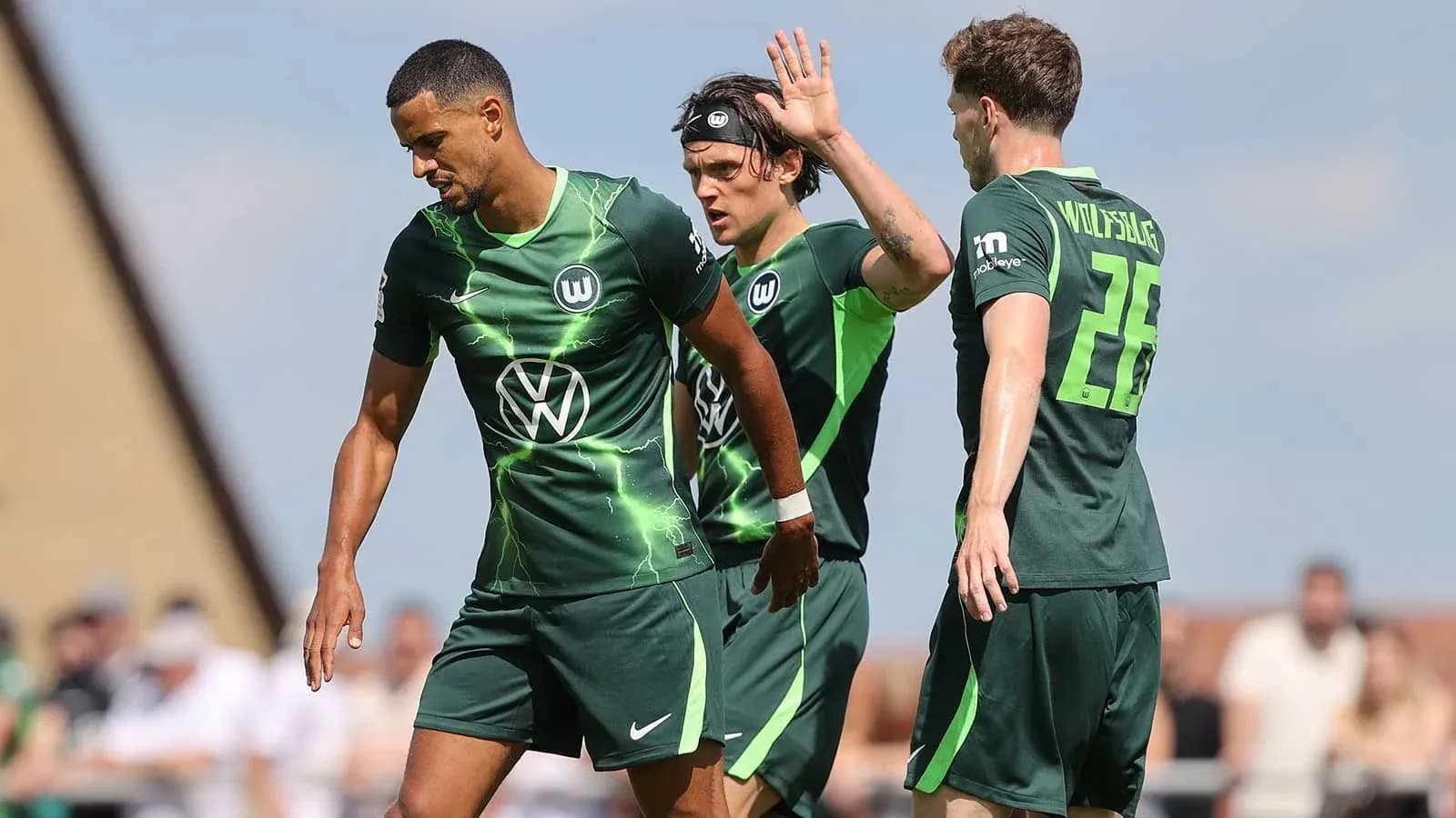 Wolfsburg players discussing during training session