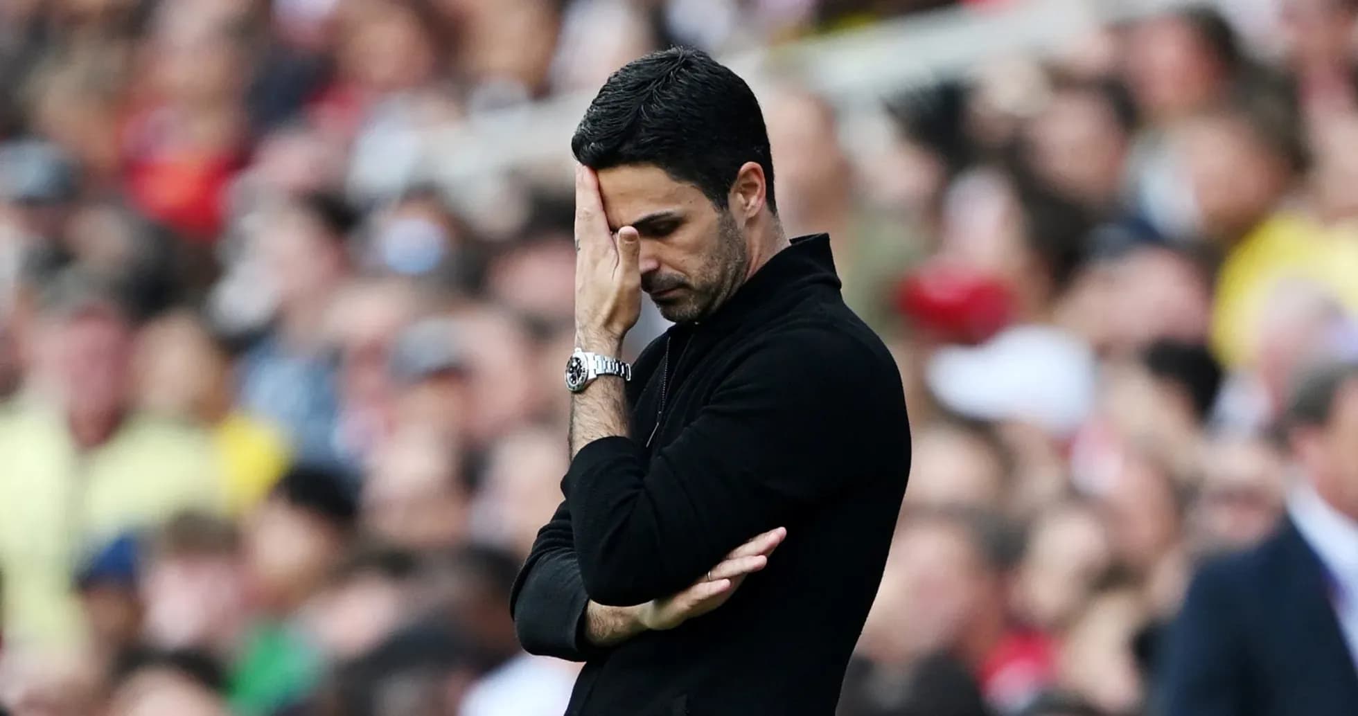 Manager with hand on forehead during match