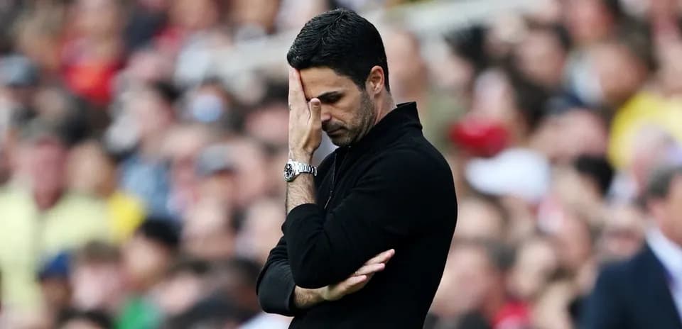 Manager with hand on forehead during match