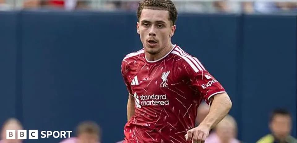 Player running in Liverpool kit during match