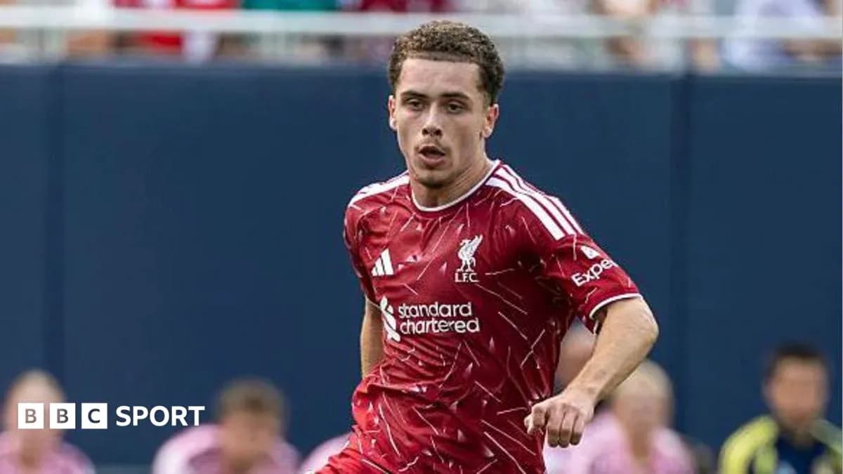 Player running in Liverpool kit during match