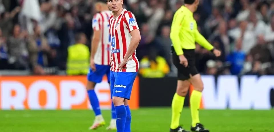 Atletico Madrid player reacting during match with referee