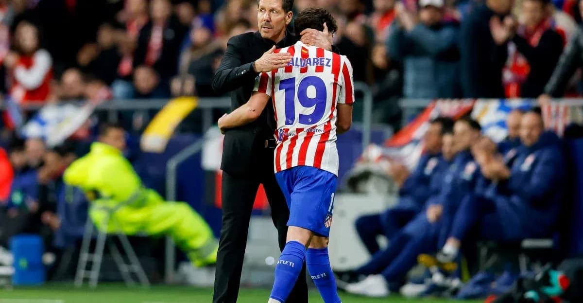 Coach embracing player after substitution during match