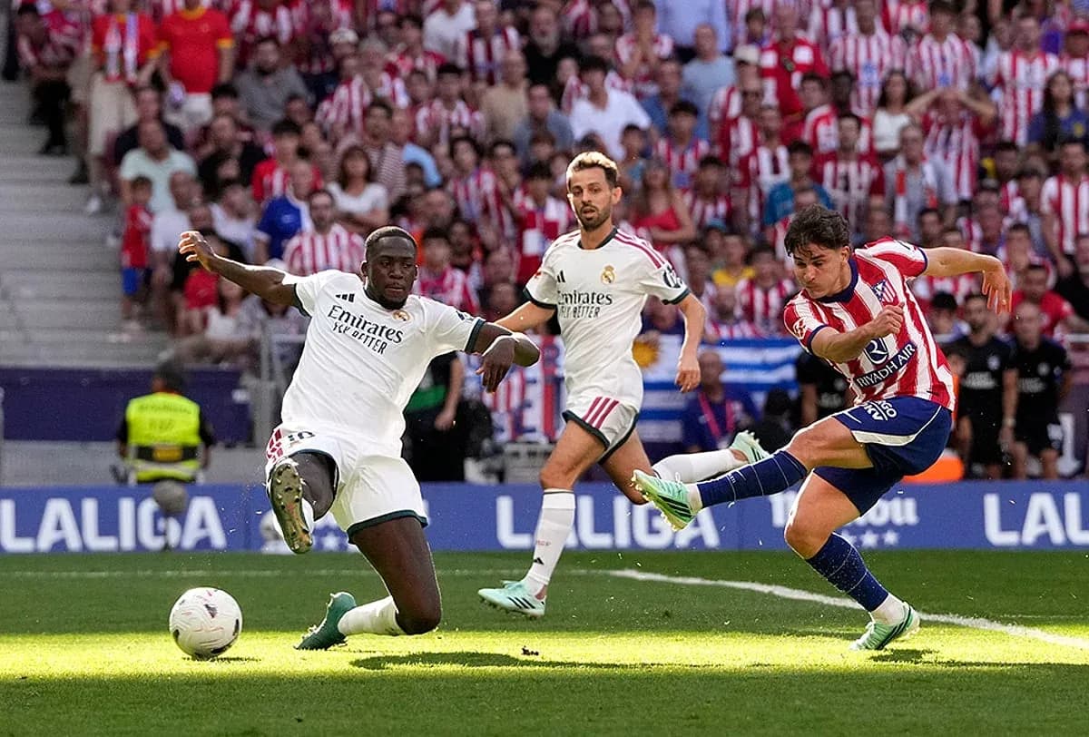 Atletico Madrid player shooting during derby match