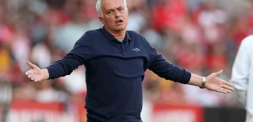 Manager gesturing during a match on the sideline