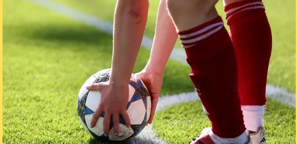 Player preparing to take a throw-in with soccer ball